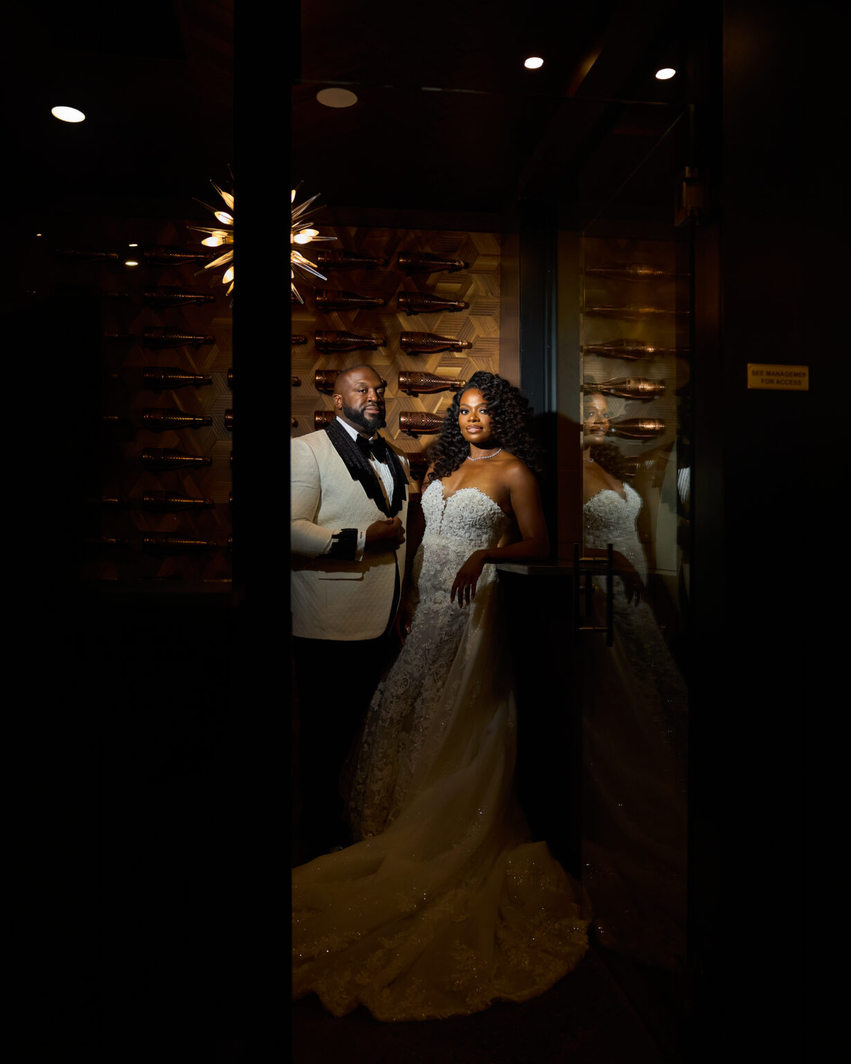 Bride and groom in a dramatically lit wine room