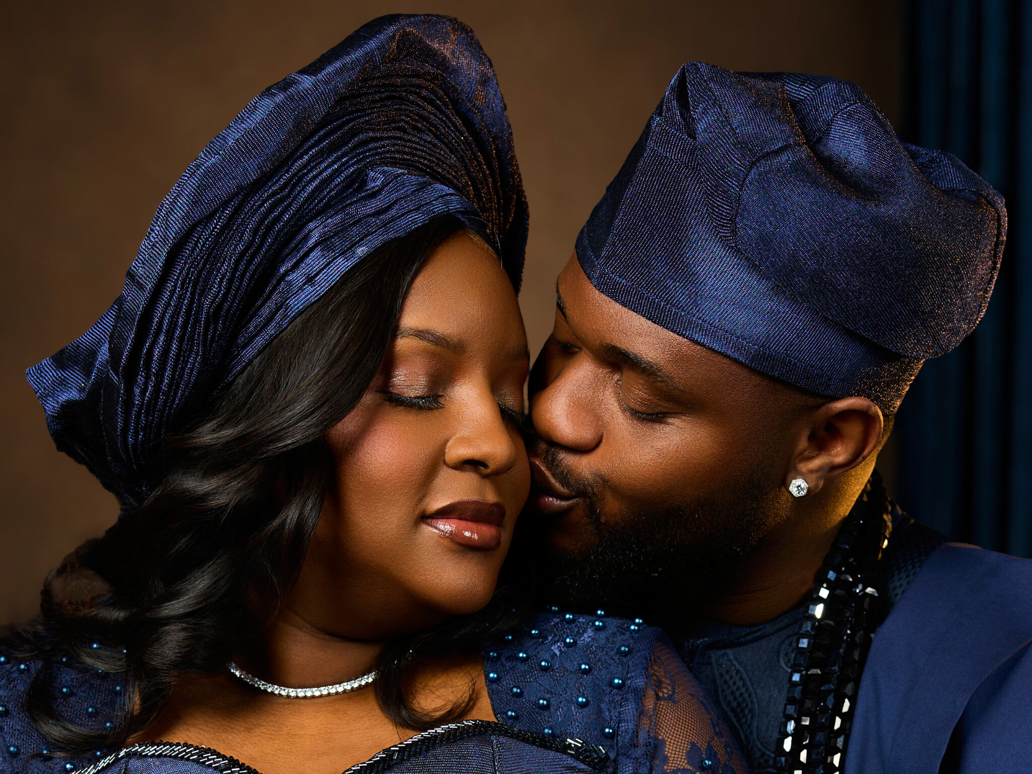 Couple sharing a tender kiss in traditional attire